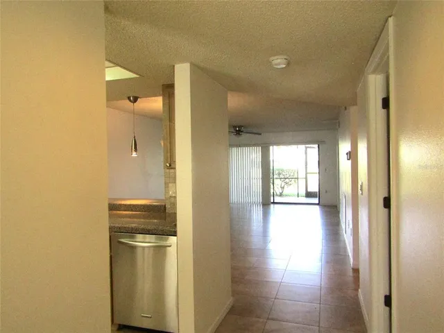 a view of a kitchen with a refrigerator and a sink