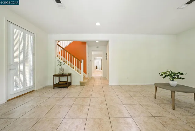 a living room with furniture a window and a table