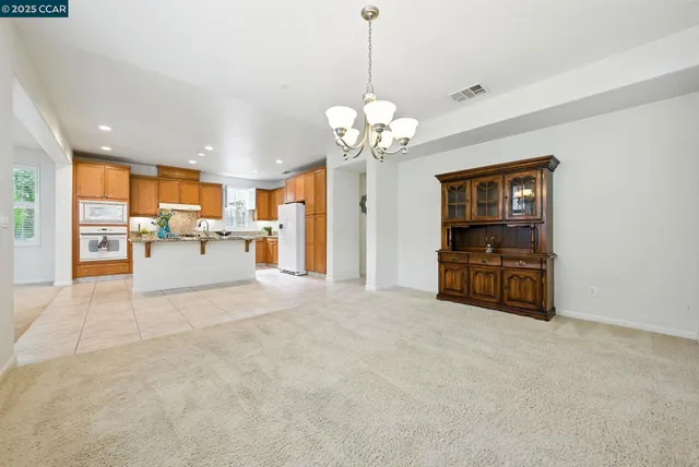 a kitchen with stainless steel appliances granite countertop a sink counter space cabinets and a refrigerator