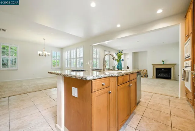 an empty room with windows and fireplace