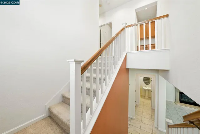 a bathroom with a granite countertop double vanity sink and a mirror