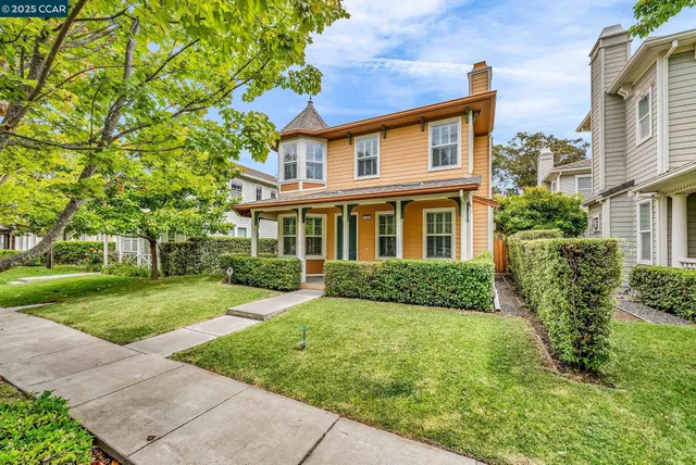 front view of a brick house with a yard