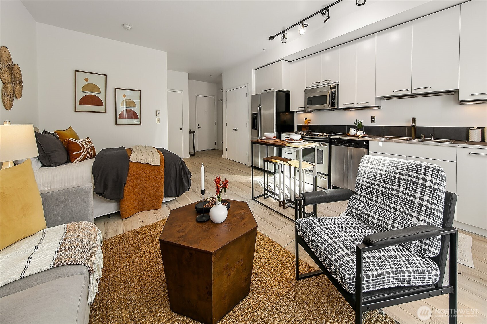 1414 12th Avenue, Unit 504 Seattle, WA 98122 - Photo 13 of 23 a living room with furniture a kitchen island and a couch