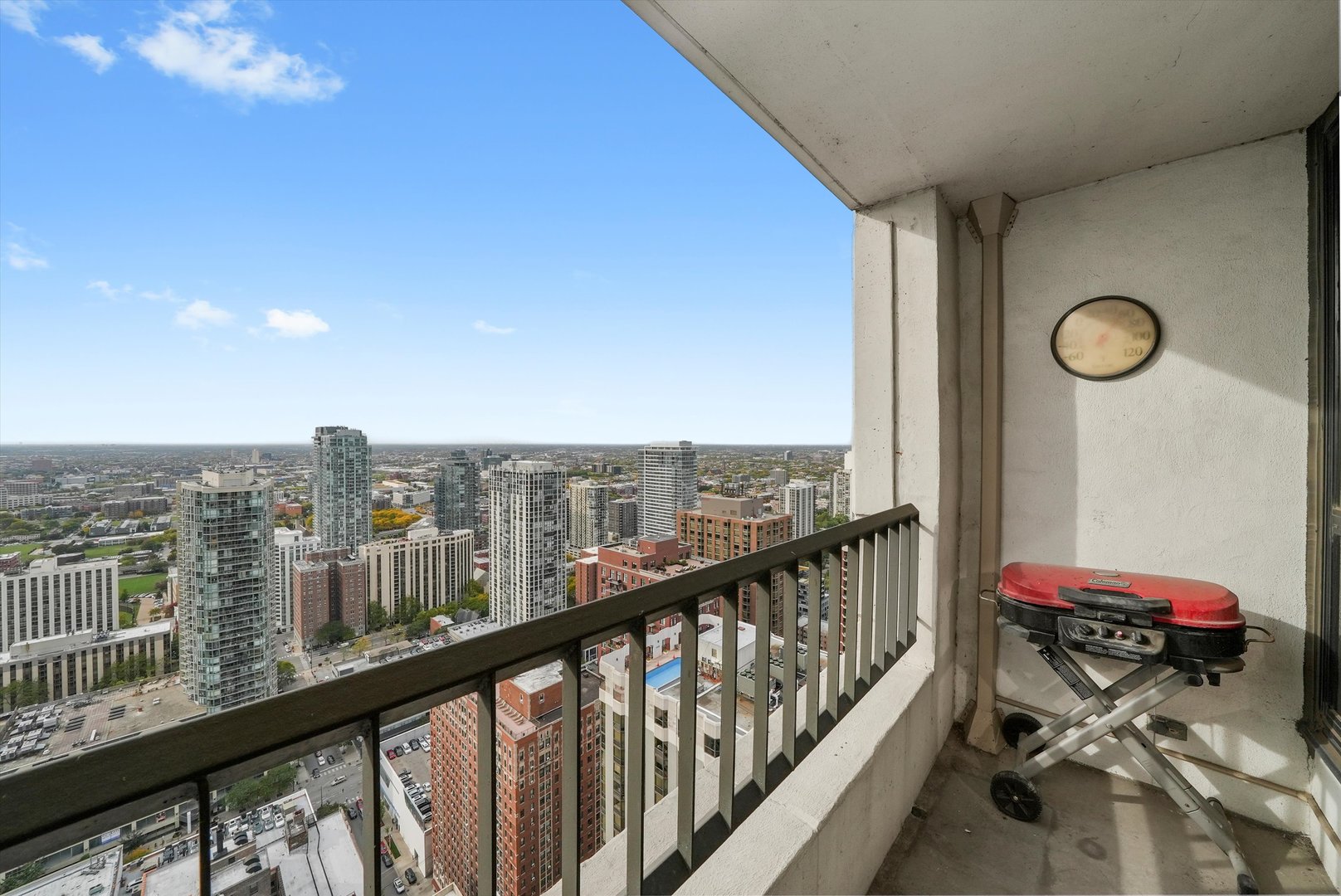 1030 North State Street, Unit 39A Chicago, IL 60610 - Photo 16 of 36 a view of a city from a balcony with furniture