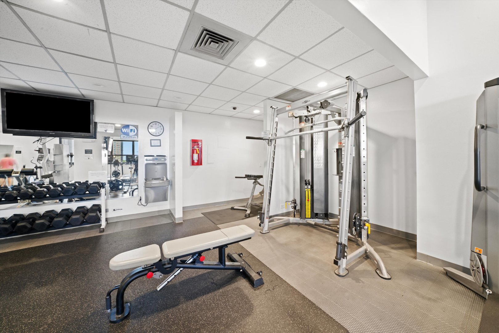 1030 North State Street, Unit 39A Chicago, IL 60610 - Photo 23 of 36 a room with gym equipment and flat screen tv