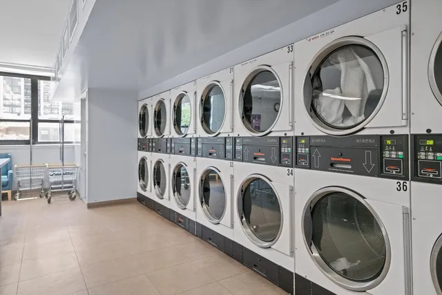 a view of a bedroom with washer and dryer