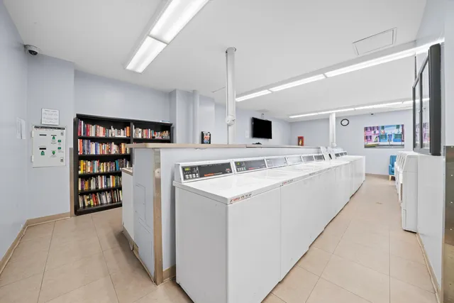a view of kitchen with cabinets and white appliances