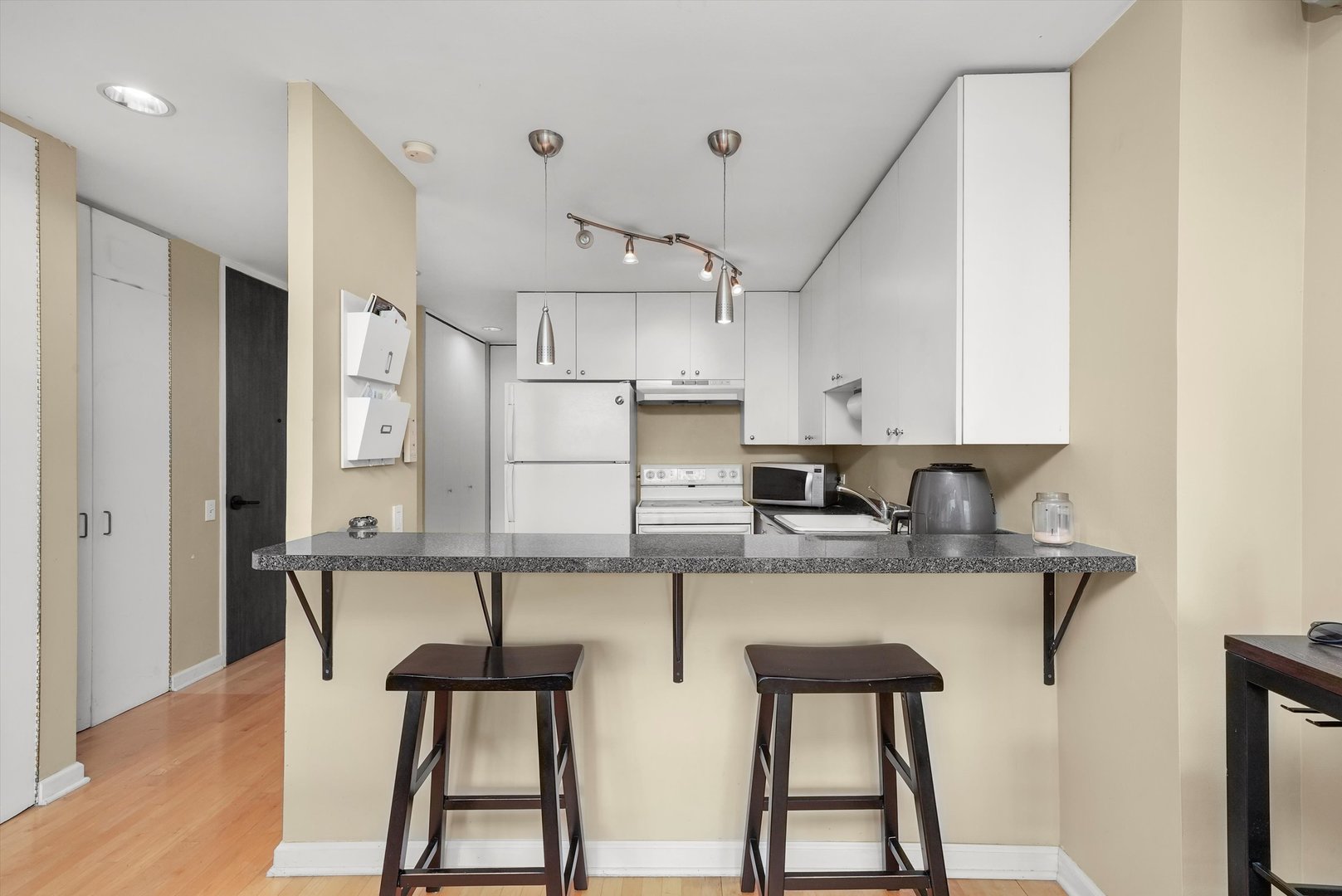 1030 North State Street, Unit 39A Chicago, IL 60610 - Photo 5 of 36 a kitchen with stainless steel appliances granite countertop a sink and a refrigerator