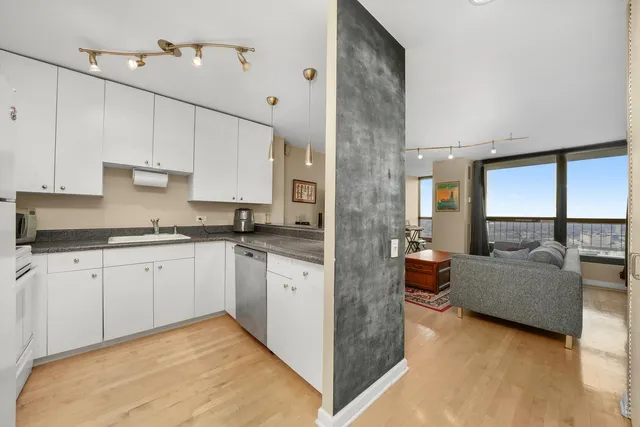a large white kitchen with a large window