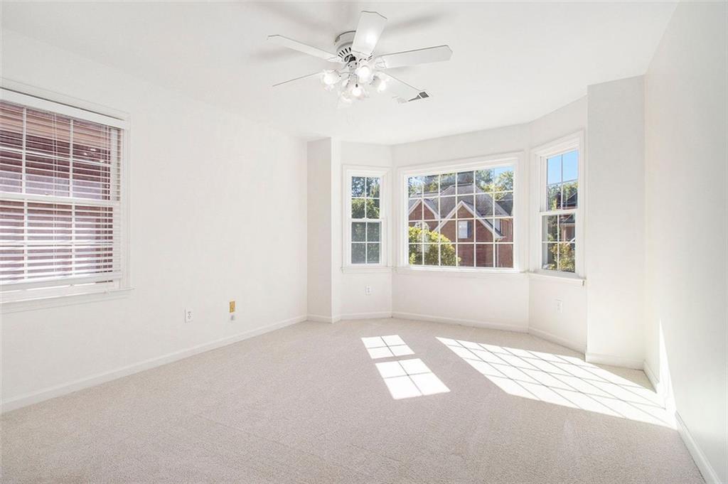2520 Summeroak Drive Tucker, GA 30084 - Photo 22 of 37 an empty room with windows and ceiling fan