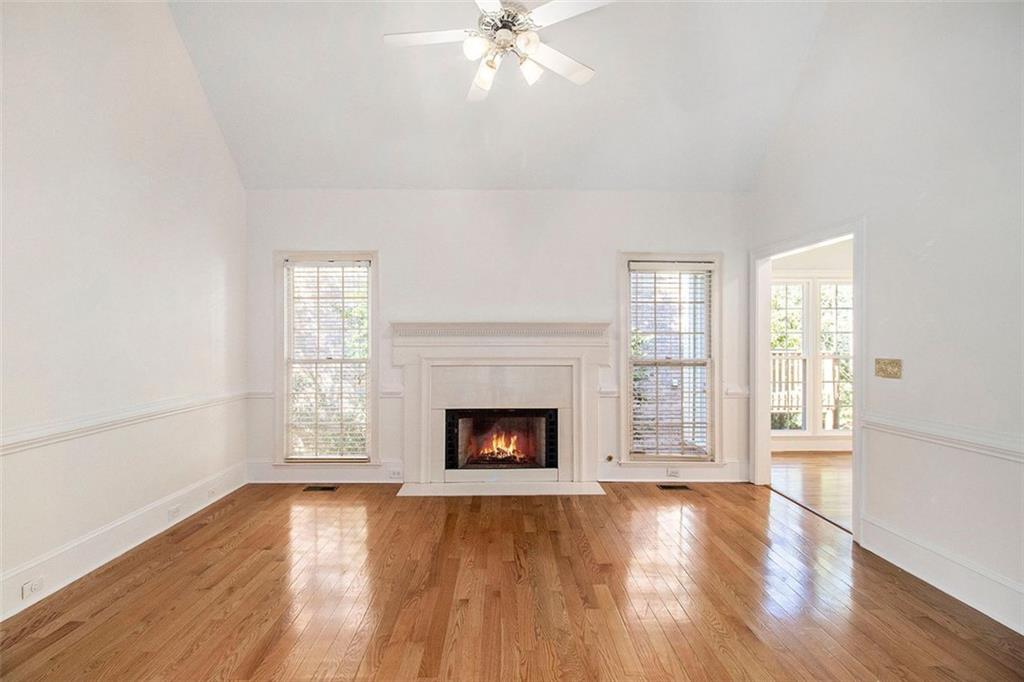 2520 Summeroak Drive Tucker, GA 30084 - Photo 6 of 37 an empty room with fireplace wooden floor and windows