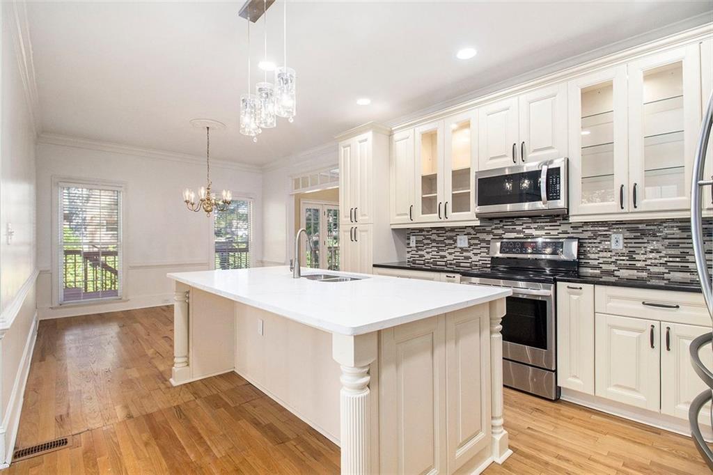 2520 Summeroak Drive Tucker, GA 30084 - Photo 8 of 37 a kitchen with stainless steel appliances granite countertop a stove top oven a sink dishwasher and a refrigerator with wooden floor
