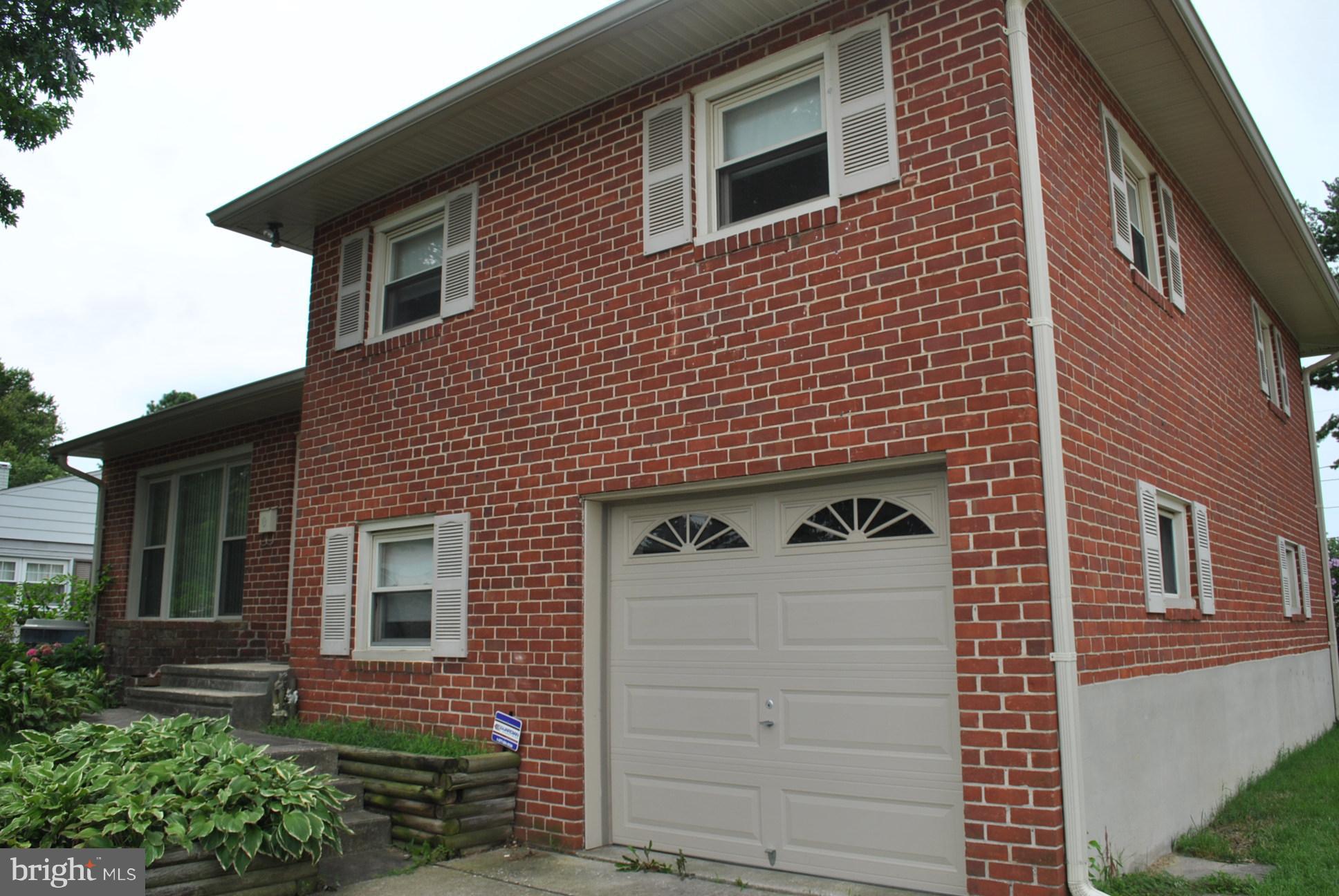 1027 Lakemont Road Baltimore, MD 21228 - Photo 2 of 14 a front view of a house with a garage