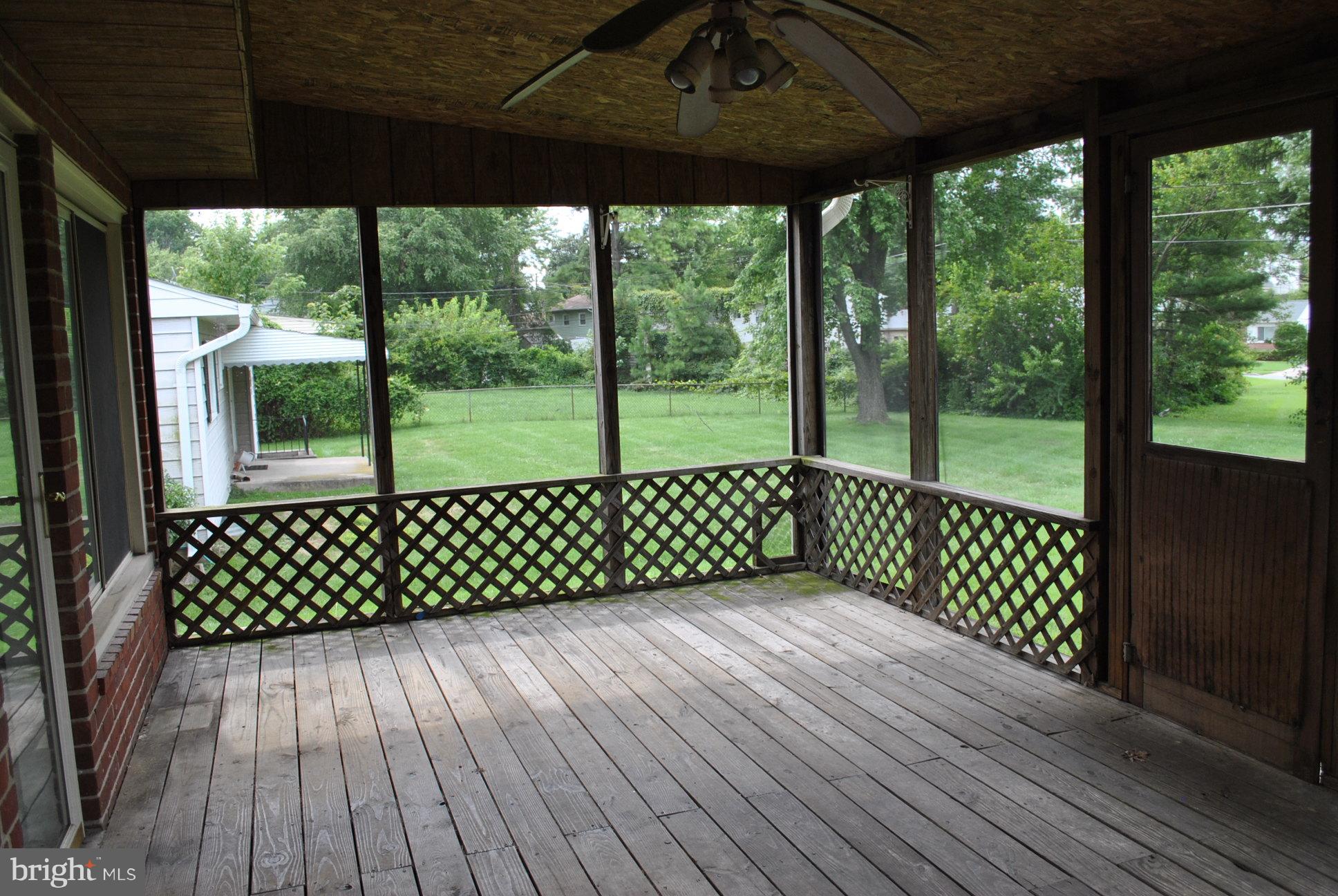 1027 Lakemont Road Baltimore, MD 21228 - Photo 13 of 14 a view of a roof deck with wooden floor and fence