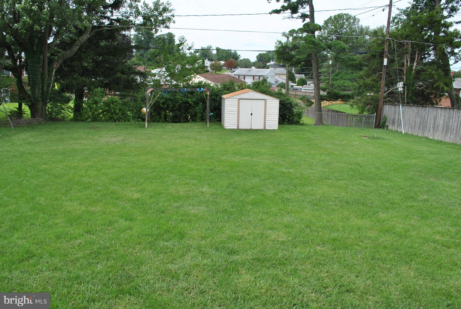 1027 Lakemont Road Baltimore, MD 21228 - Photo 14 of 14 a view of a backyard with a small cabin