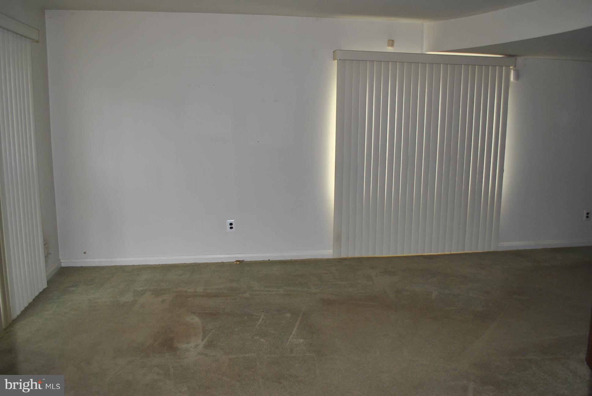 1027 Lakemont Road Baltimore, MD 21228 - Photo 5 of 14 a view of an empty room with a window