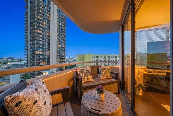 a balcony with table and chairs