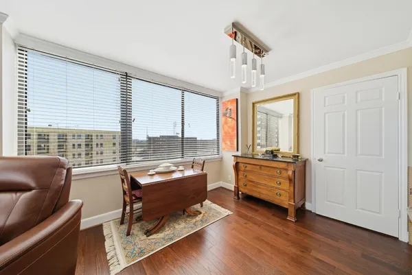 a room with pool table and windows