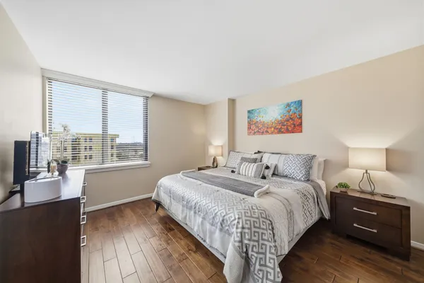 a bedroom with a bed and wooden floor
