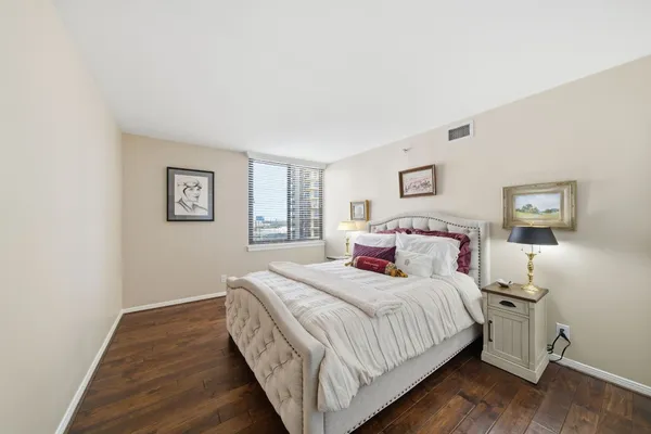 a bed room with a bed and a night stand