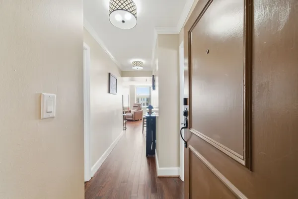 a view of a hallway with wooden floor