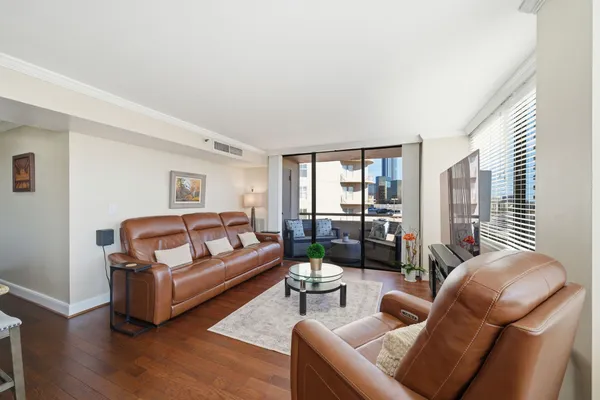 a living room with furniture and a wooden floor