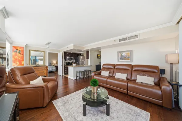 a living room with furniture or couch and a wooden floor