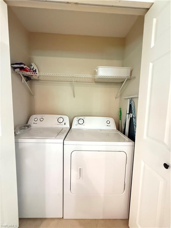 6140 Standing Oaks Lane Naples, FL 34119 - Photo 12 of 13 a utility room with dryer and washer