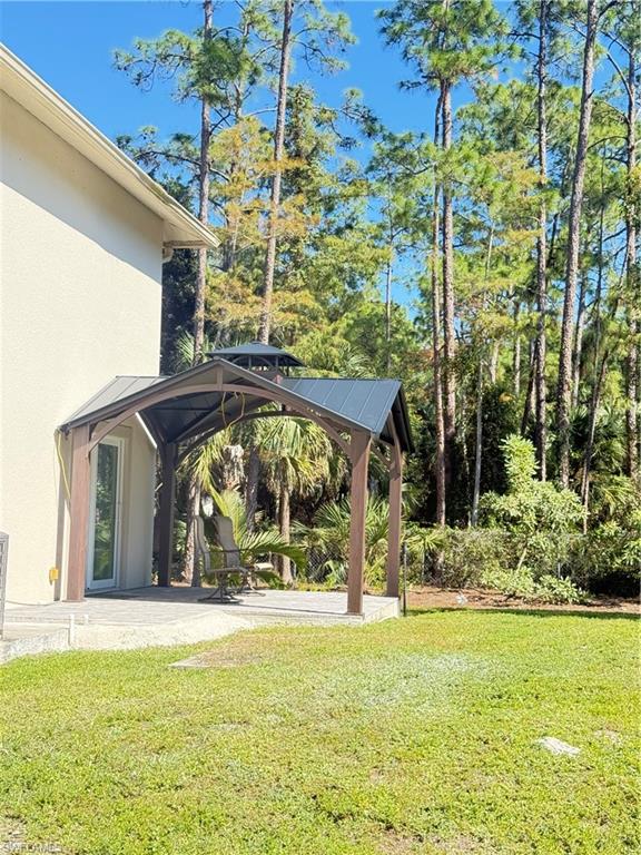 6140 Standing Oaks Lane Naples, FL 34119 - Photo 13 of 13 a view of a house with a yard