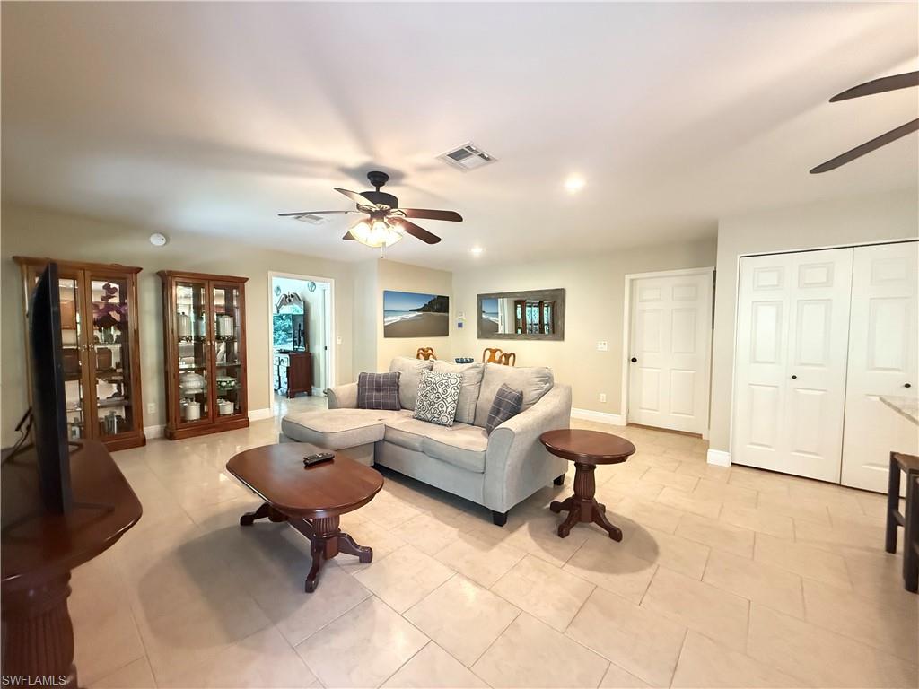 6140 Standing Oaks Lane Naples, FL 34119 - Photo 4 of 13 a living room with furniture and a large window