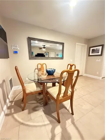 a dining room with furniture and a flat screen tv