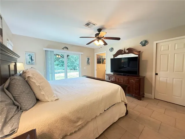 a bedroom with a bed and a tv