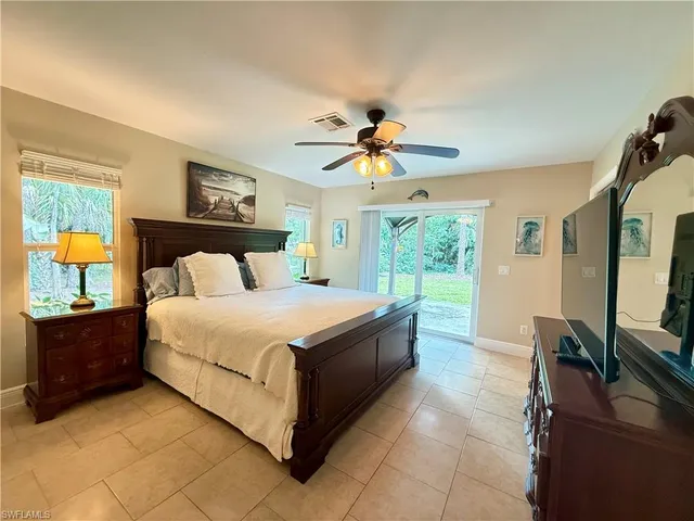 a bed room with a bed and a chandelier