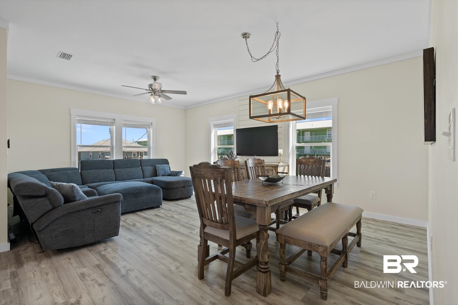 2586 Muscogee Road Gulf Shores, AL 36542 - Photo 18 of 55 Dining area featuring ceiling fan with notable chandelier, light hardwood / wood-style flooring, and ornamental molding