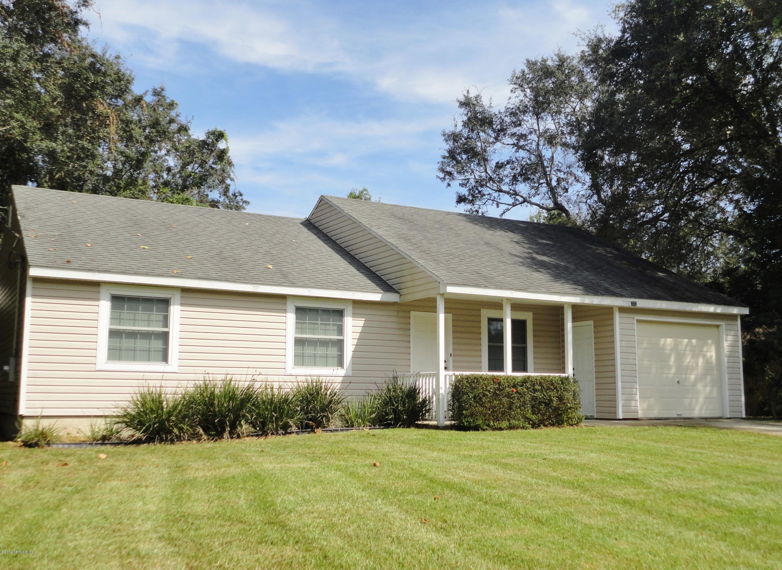 323 Gentian Road St. Augustine, FL 32086 - Photo 1 of 24 a front view of a house with a yard and garage