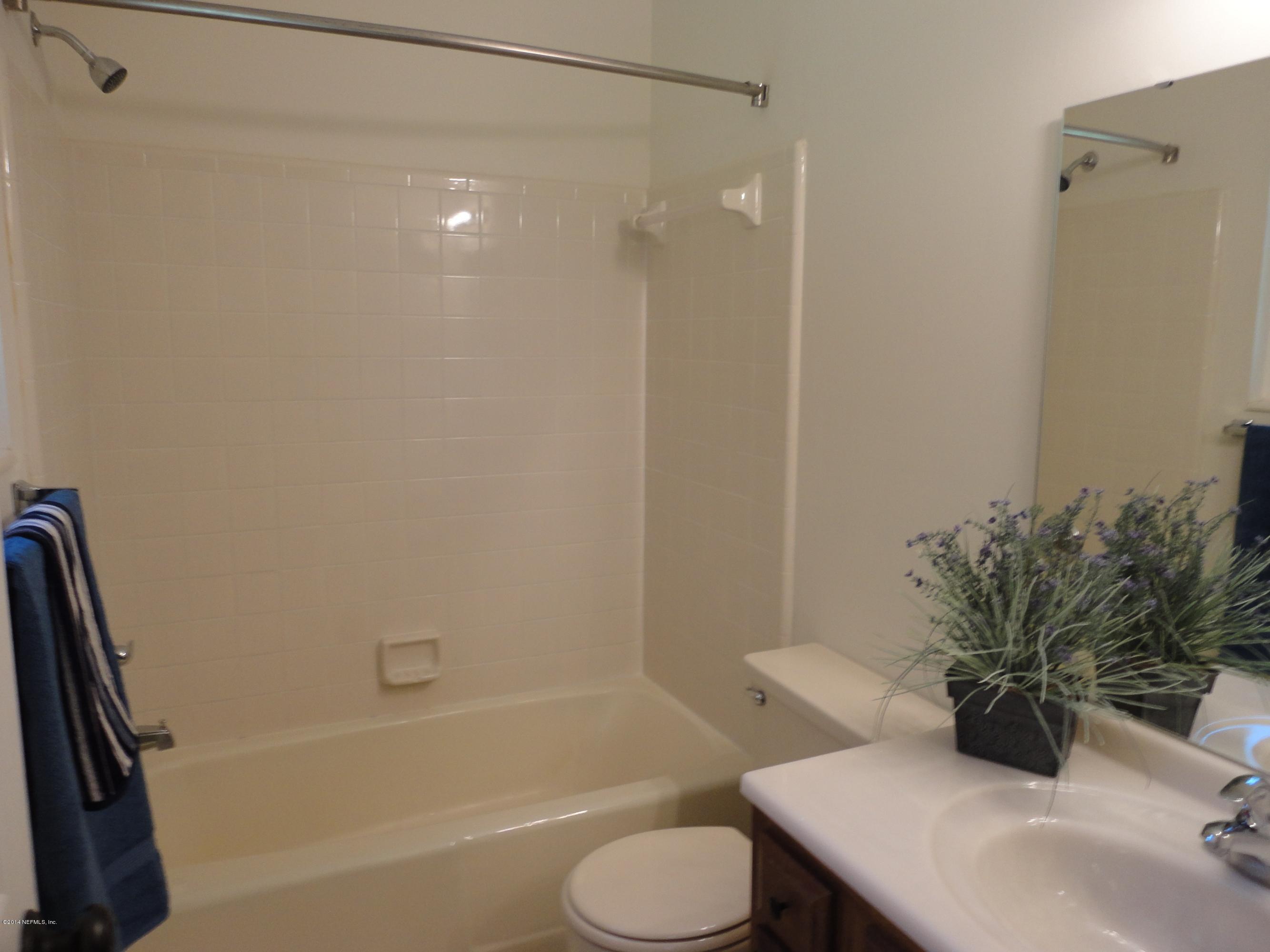 323 Gentian Road St. Augustine, FL 32086 - Photo 13 of 24 a bathroom with a sink toilet and shower