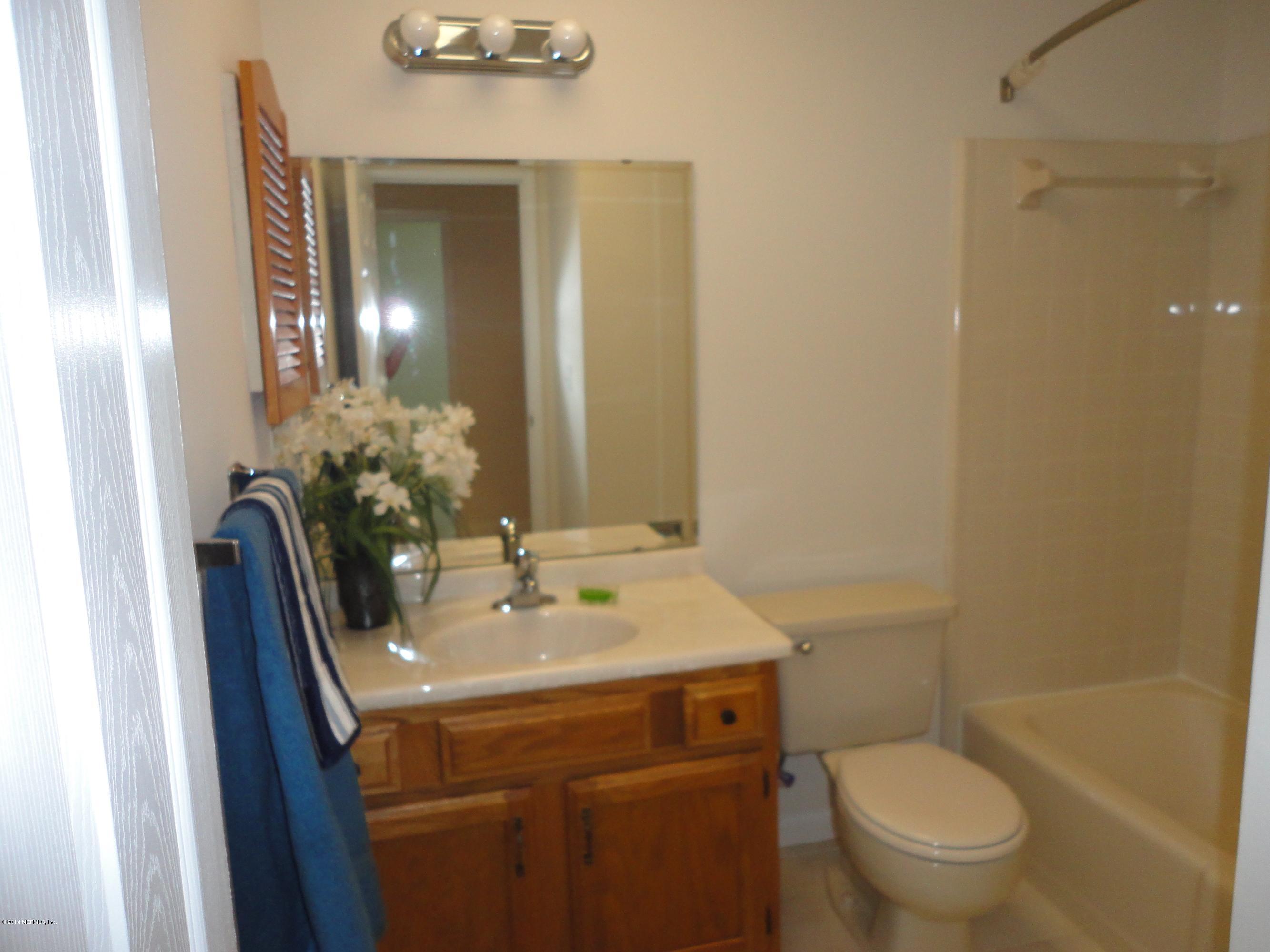 323 Gentian Road St. Augustine, FL 32086 - Photo 17 of 24 a bathroom with a sink toilet and mirror
