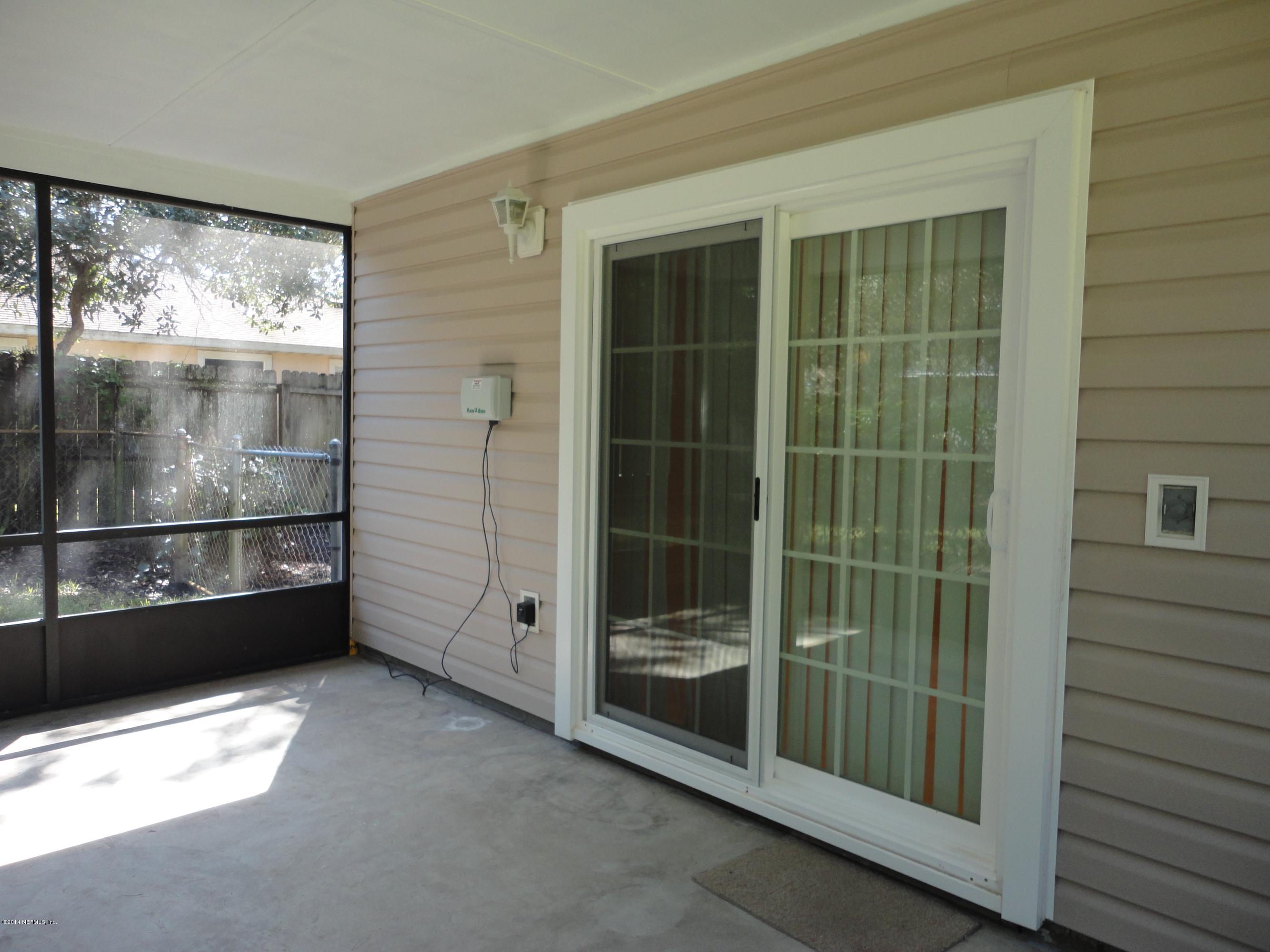 323 Gentian Road St. Augustine, FL 32086 - Photo 22 of 24 a view of a glass door and a window