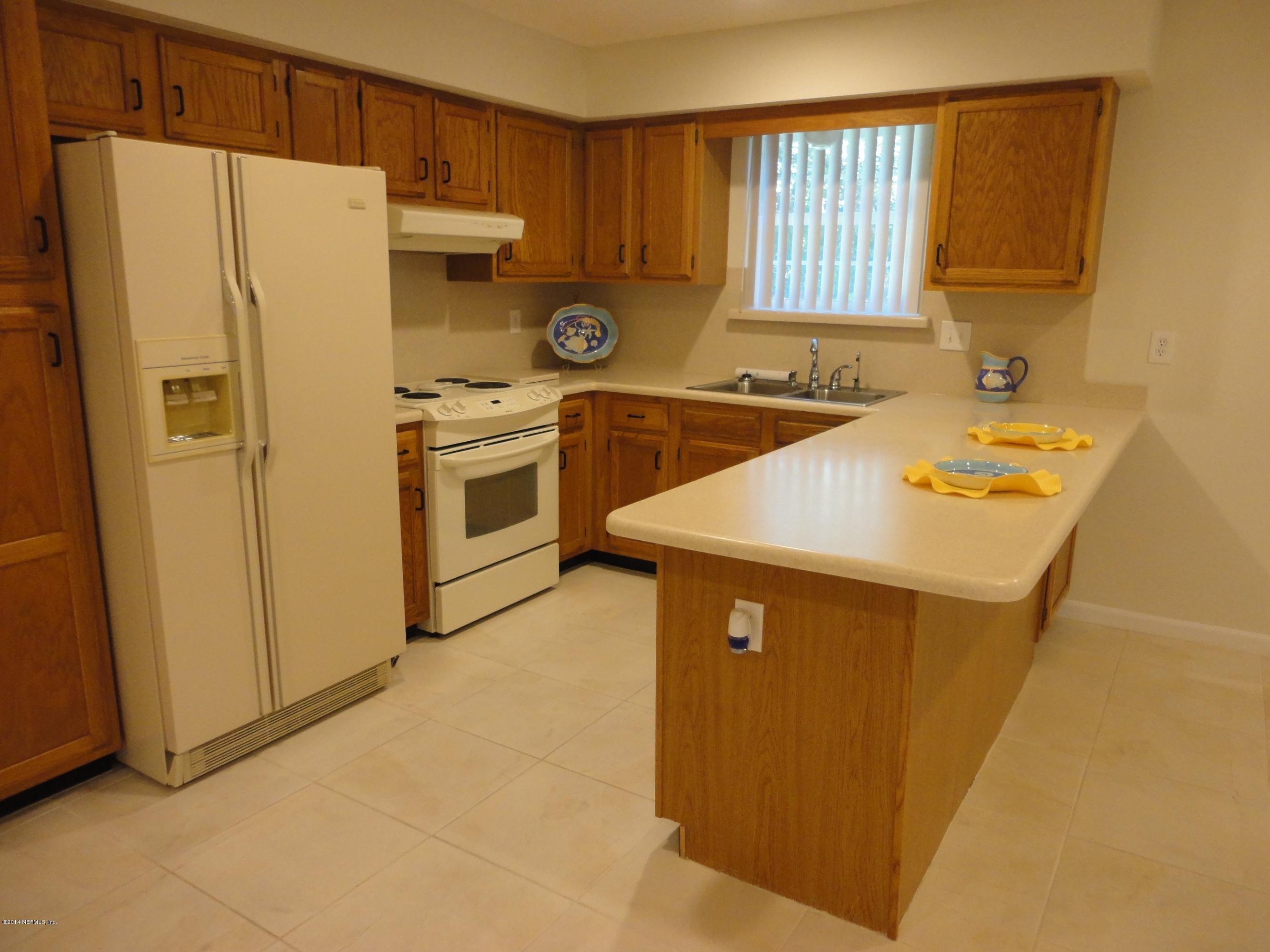 323 Gentian Road St. Augustine, FL 32086 - Photo 5 of 24 a white refrigerator freezer sitting inside of a kitchen