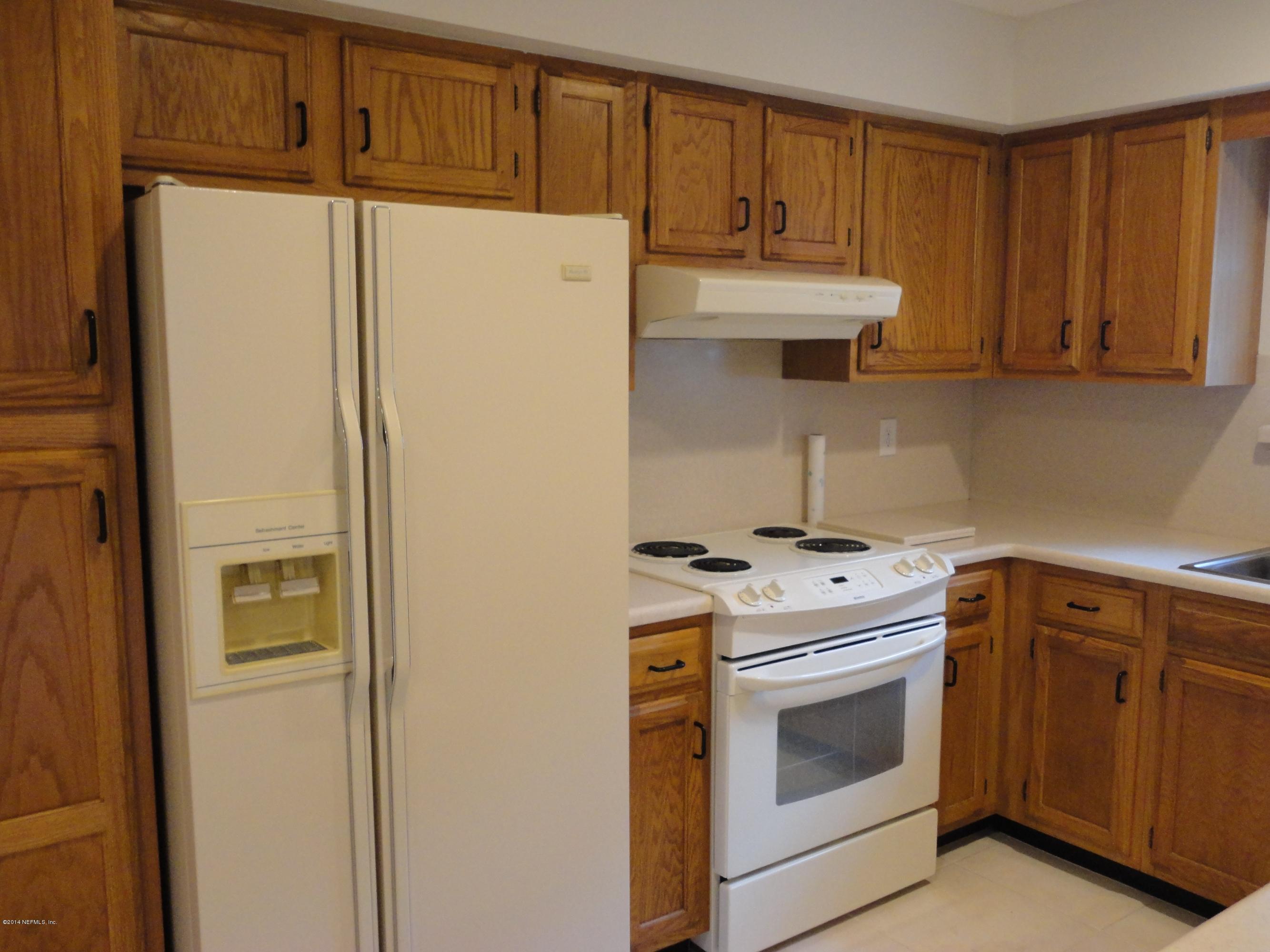 323 Gentian Road St. Augustine, FL 32086 - Photo 6 of 24 a kitchen with a stove top oven sink and refrigerator