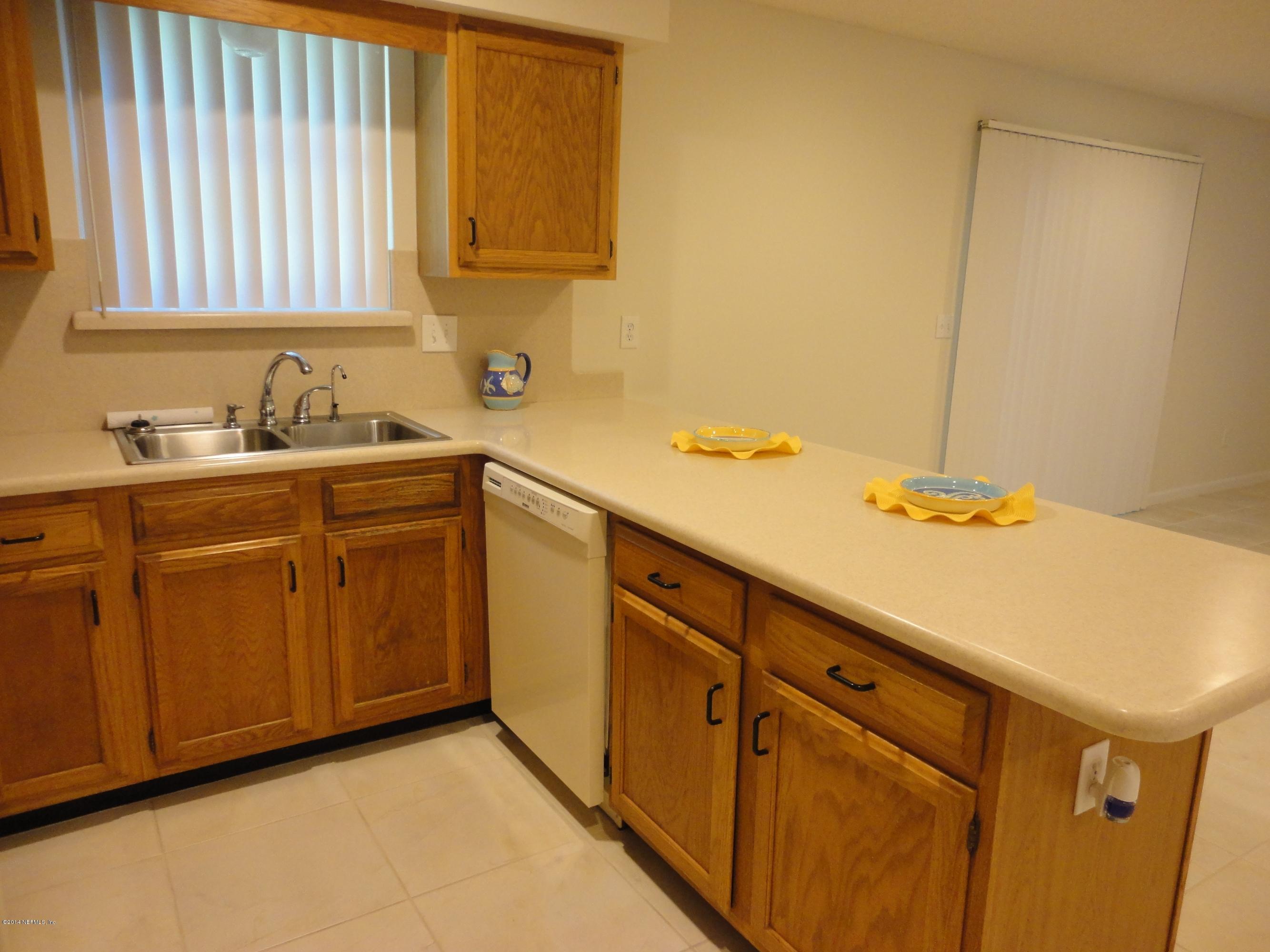 323 Gentian Road St. Augustine, FL 32086 - Photo 7 of 24 a kitchen with a sink cabinets and a window