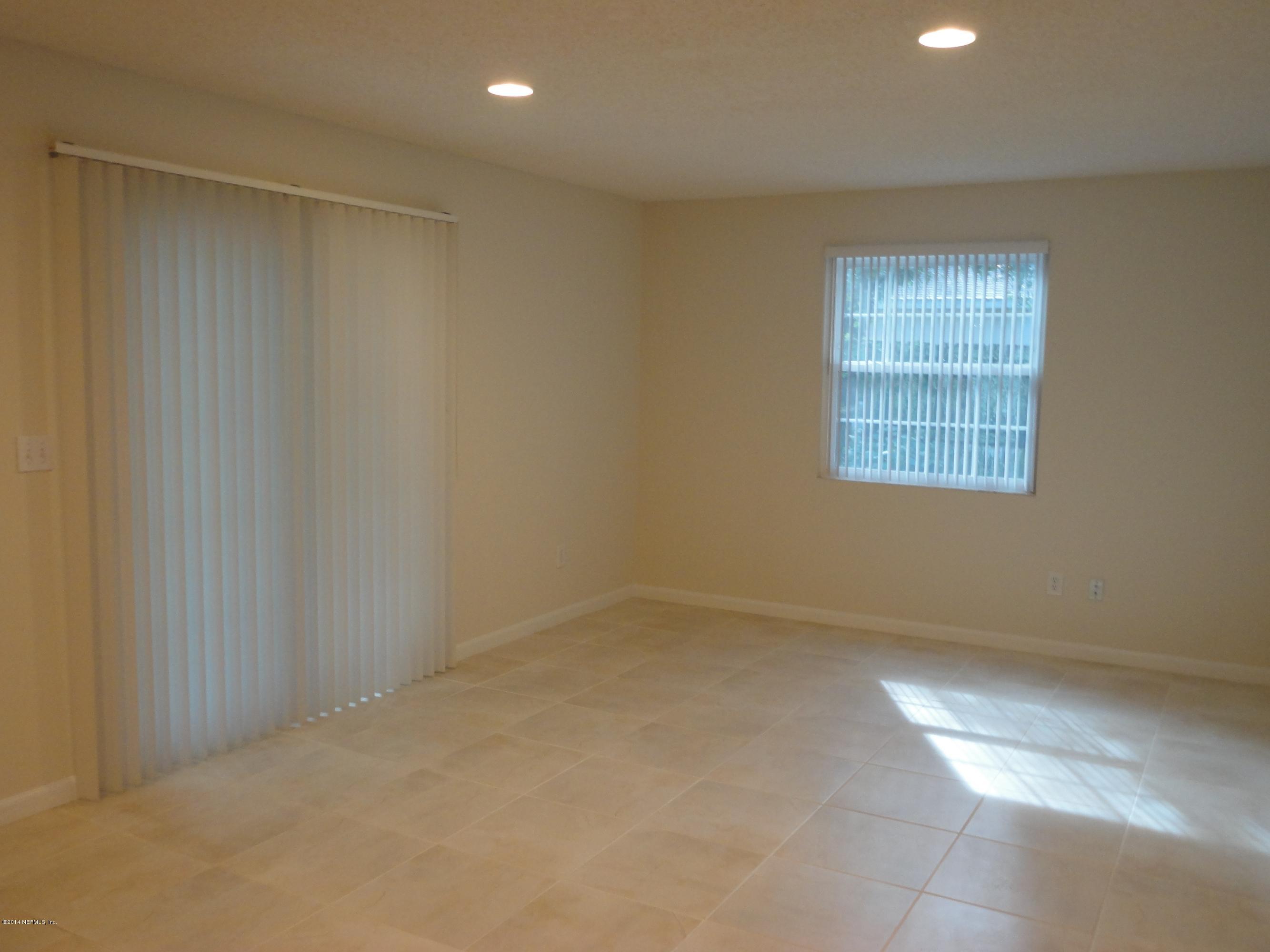 323 Gentian Road St. Augustine, FL 32086 - Photo 9 of 24 an empty room with a empty space and windows
