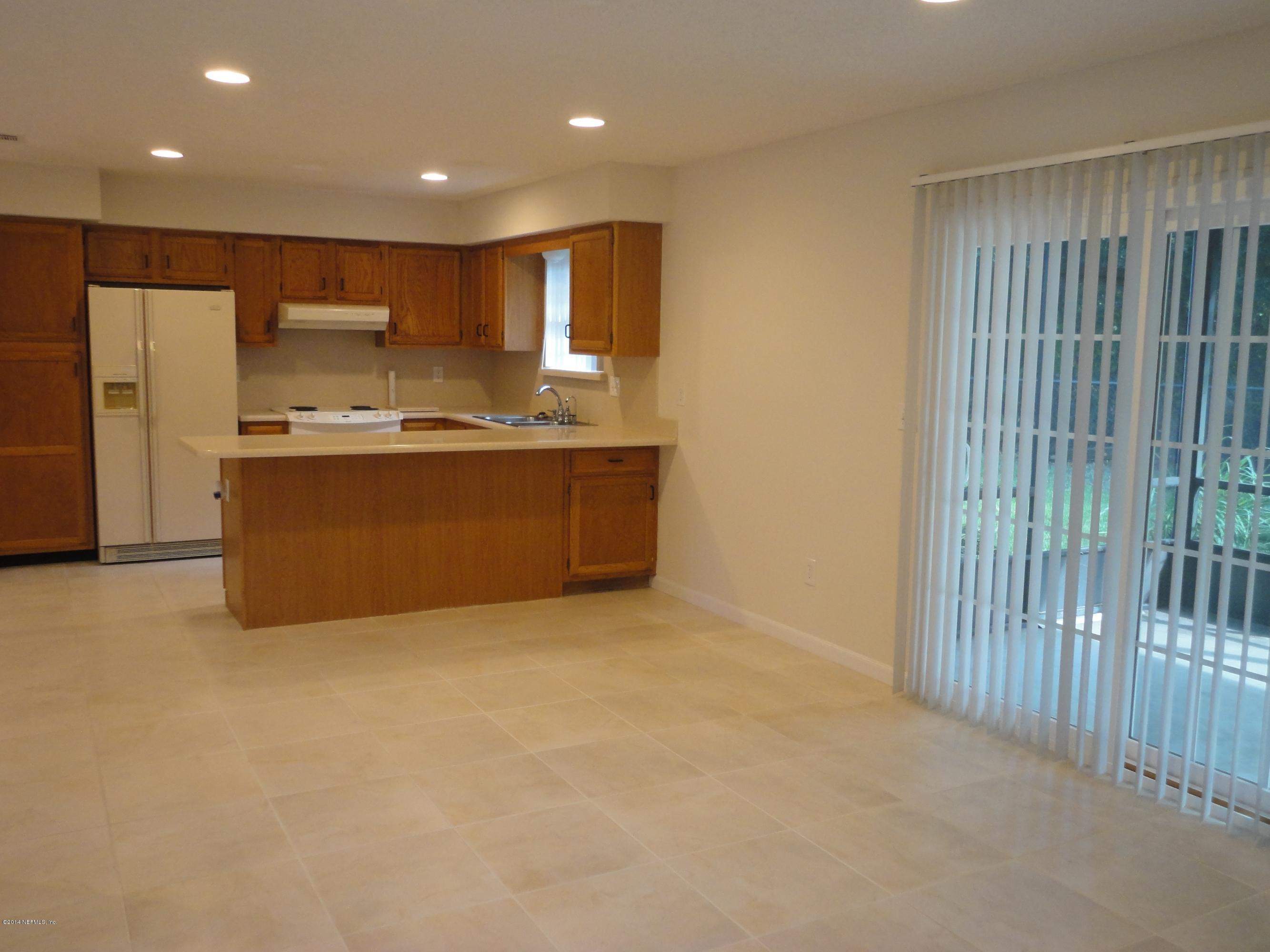 323 Gentian Road St. Augustine, FL 32086 - Photo 10 of 24 a view of kitchen with stainless steel appliances granite countertop cabinets and outdoor space