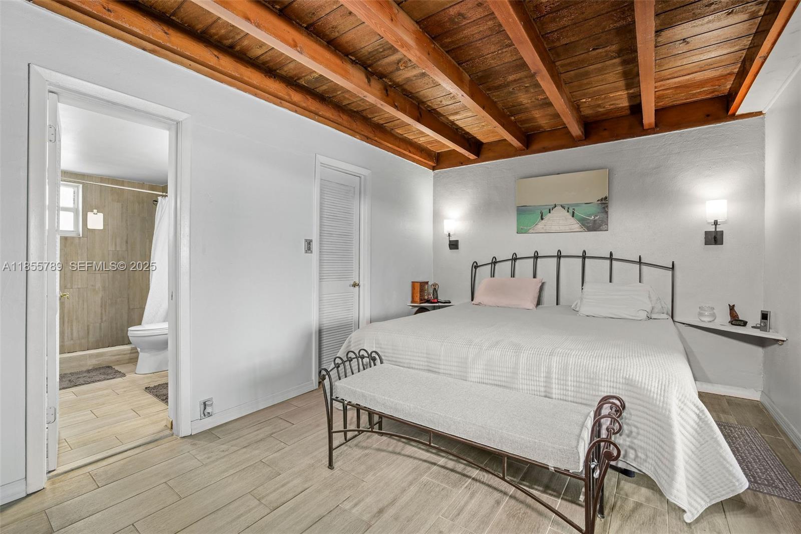 7550 Southwest 28th Street Road Miami, FL 33155 - Photo 12 of 27 a spacious bedroom with a bed and a table