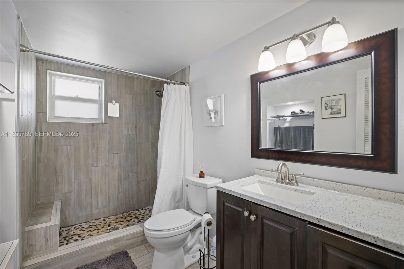 7550 Southwest 28th Street Road Miami, FL 33155 - Photo 14 of 27 a bathroom with a granite countertop sink toilet and shower