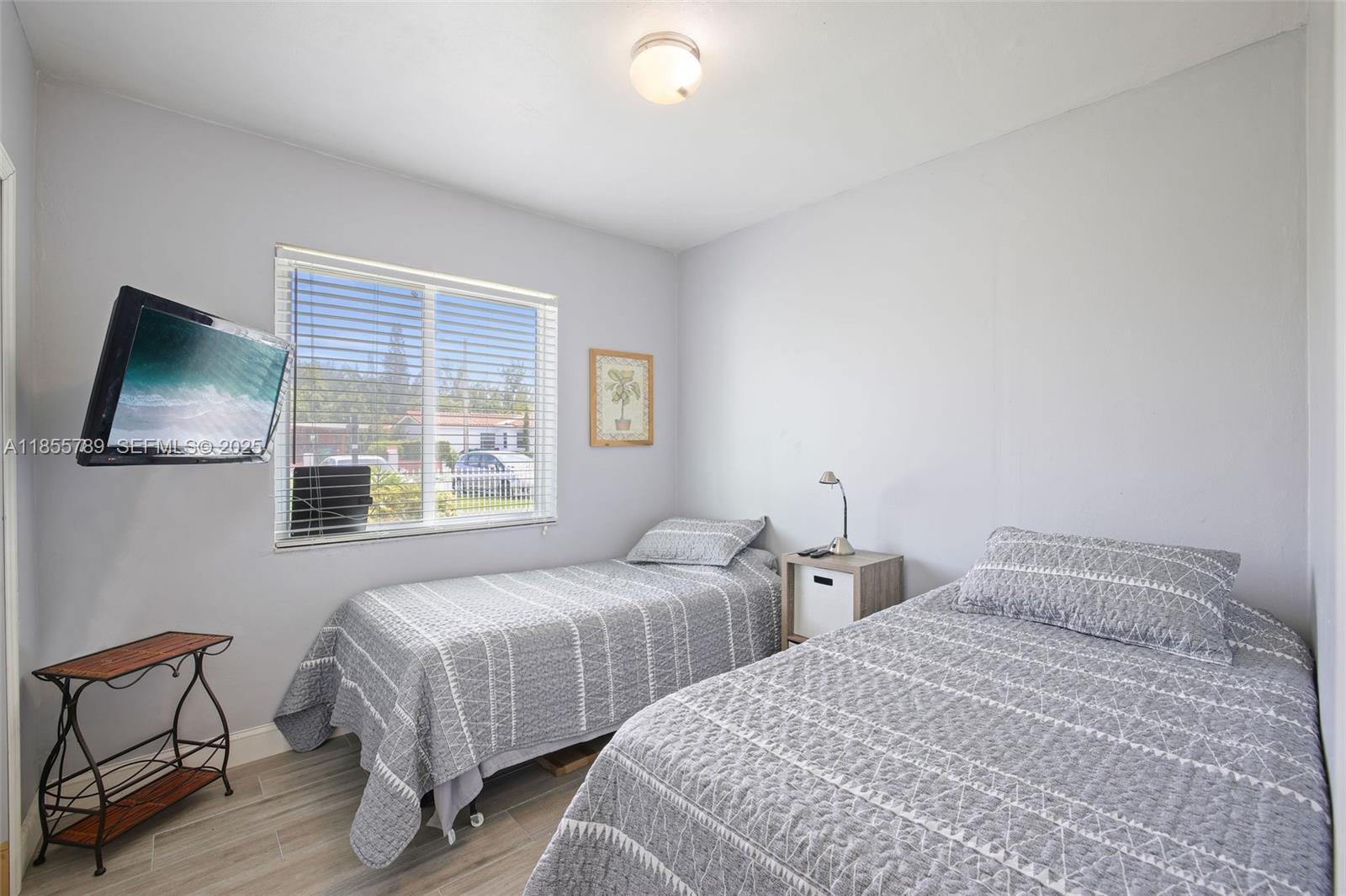 7550 Southwest 28th Street Road Miami, FL 33155 - Photo 15 of 27 a bedroom with two beds and a flat screen tv