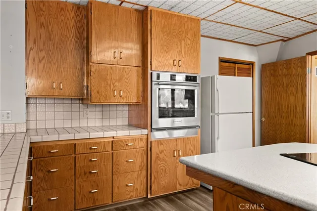 a kitchen with stainless steel appliances granite countertop a sink stove and wooden floor
