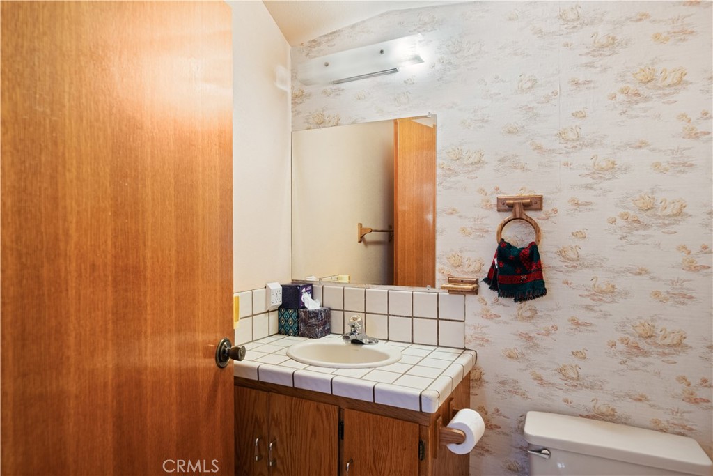 4345 Hall Road Corning, CA 96021 - Photo 28 of 52 a bathroom with a sink a toilet and mirror