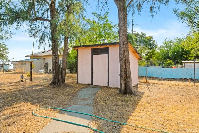 a view of backyard of house and car parked