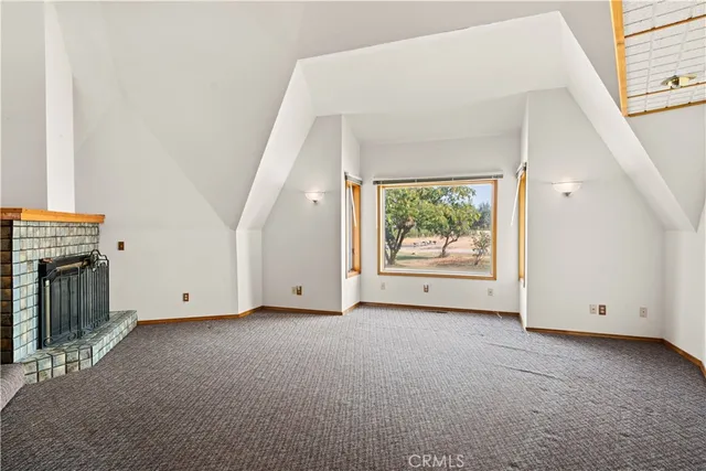 a view of an empty room with a fireplace